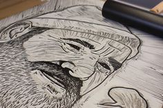 a drawing of a man with a beard and hat on top of a piece of paper