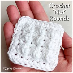 a hand holding a crochet not rounds square