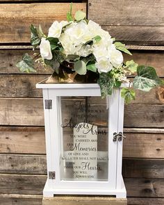 a vase filled with white flowers sitting on top of a table