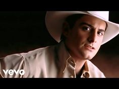 a man wearing a white cowboy hat and tan shirt