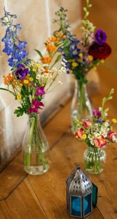 three vases filled with different types of flowers