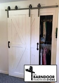 the interior of a bedroom with two sliding barn doors and carpeted flooring in front of it