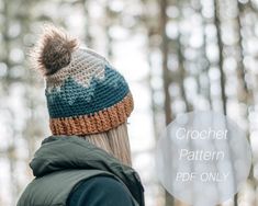 a woman wearing a crochet hat with a pom - pom in the woods