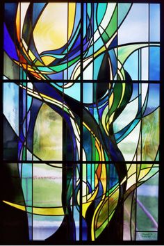 a stained glass window with an abstract design in the center and words, atelier messdah