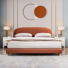 a bed with an orange headboard and two lamps on either side of the bed