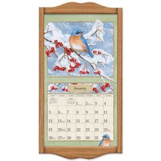 a calendar with a blue bird sitting on top of a tree branch in the snow