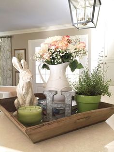 a tray with some flowers and candles on it