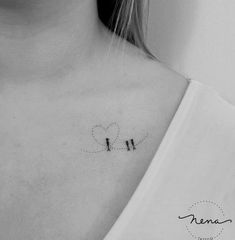 a black and white photo of a woman's chest with two birds on it