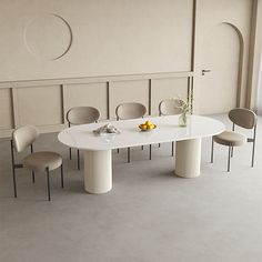 a white table with four chairs around it