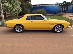 a yellow car parked in a parking lot