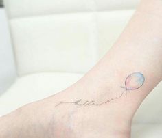 a person with a balloon tattoo on their foot