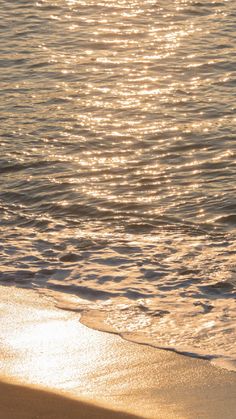 the sun is shining on the water at the beach