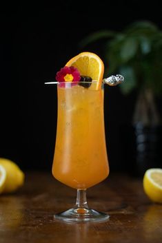 a glass filled with lemonade and garnish on top of a wooden table