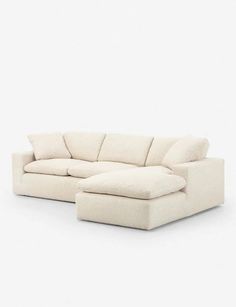 a large white couch sitting on top of a white floor