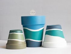 three ceramic cups sitting next to each other