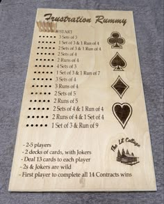 a wooden board with instructions for playing cards