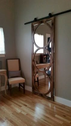 the sliding door is made from wood and has been installed in an empty living room