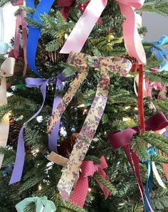 a decorated christmas tree with ribbons on it