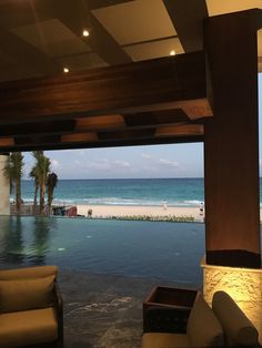 an outdoor swimming pool next to the ocean