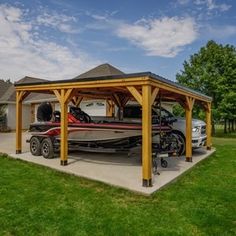 a car is parked in front of a house with a boat attached to the roof