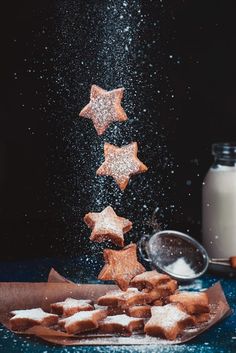 some sugar stars are falling out of a jar