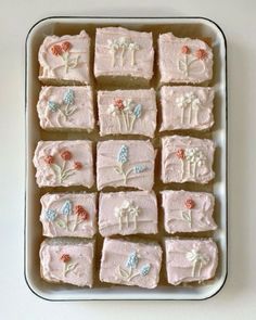 there are many square pieces of cake that have flowers on them