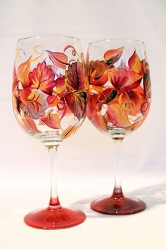 two wine glasses with flowers painted on them