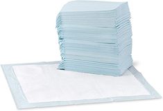 a stack of blue napkins sitting on top of a white sheet covered in paper