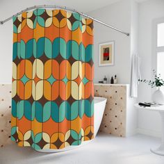 an orange and blue shower curtain with circles on it in a white bathroom next to a bathtub