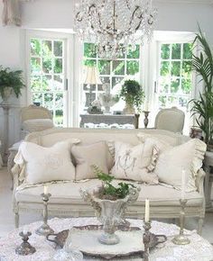 a living room filled with furniture and a chandelier