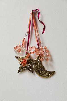 an ornament hanging on a wall with beads