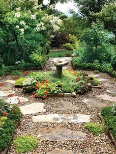 a stone path in the middle of a garden