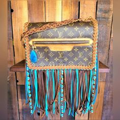 This Pre-Owned Louis Vuitton St. Germain Bag Features Custom Intricate, Hand-Crafted Needlework, And Fringing That Is Bound To Turn Heads And Spark Fresh Conversation . This Louis Vuitton Bag Exudes Elegance And Sophistication. The Meticulous Attention To Detail Is Evident, Making It A True Symbol Of Luxury. It’s Made With Brown, Tan, And Turquoise Genuine Leather Braid And Fringe. Make A Bold Statement And Set Yourself Apart From The Crowd With This Remarkable Lv Bag, Ensuring That Your Bag Is Revamped Louis Vuitton Western, Boho Western Style, Fringe Braid, Braided Fringe, Pre Owned Louis Vuitton, St Germain, Vuitton Bag, Lv Bag, Western Style