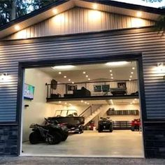 a garage with two cars in it and stairs leading up to the second story area