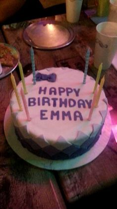 a birthday cake sitting on top of a wooden table