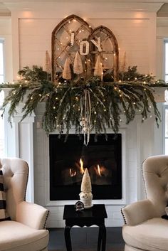 a living room filled with furniture and a fire place covered in greenery next to a fireplace