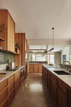 a kitchen with wooden cabinets and white counter tops