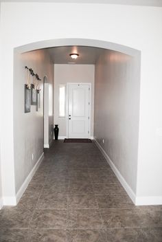 an empty hallway leading to a white door