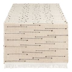 a white table runner with black dots on it