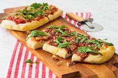 two pizzas sitting on top of wooden cutting boards