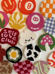 several different types of felt badges on a white surface with the words sew give love written in them