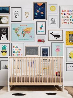 a baby's room with lots of pictures on the wall and a crib