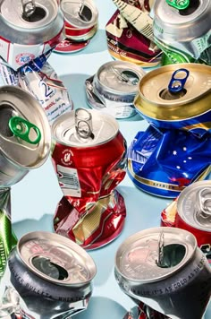 many cans of soda are stacked on top of each other