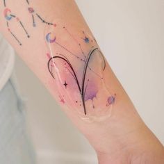 a woman's arm with tattoos on it and stars in the sky behind her