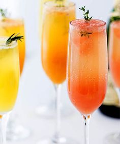 three champagne flutes filled with different types of drinks