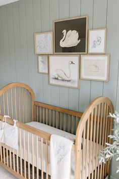 a baby's crib with pictures on the wall