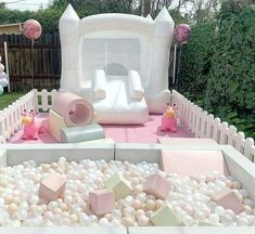 an inflatable play area with pink and white balls