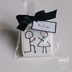 a cake in the shape of a man and woman with a thank you tag on it