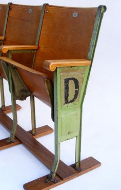 three wooden chairs with letters on them sitting side by side