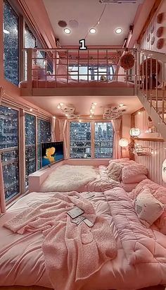 a bedroom with pink bedding and stairs leading up to the second floor in an apartment